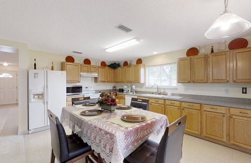 Westside House | Spacious home with sunroom, patio, fireplace, & water views