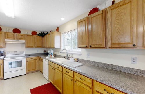 Westside House | Spacious home with sunroom, patio, fireplace, & water views