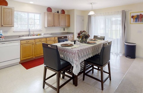 Westside House | Spacious home with sunroom, patio, fireplace, & water views