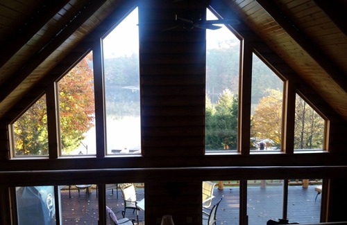 Treasure Lake House | Spacious Lakefront Log Home with large lakefront porch, firepit