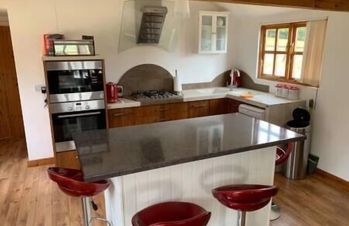 Horspath House | Stable lodge with cosy log fire