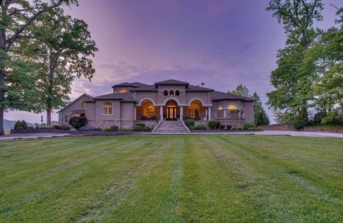 Earlville Villa | Stunning waterfront villa with indoor pool and kids swing set and play area.