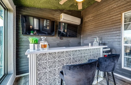 San Angelo House | Stylish corner home with cozy interiors, a private bar, and inviting charm