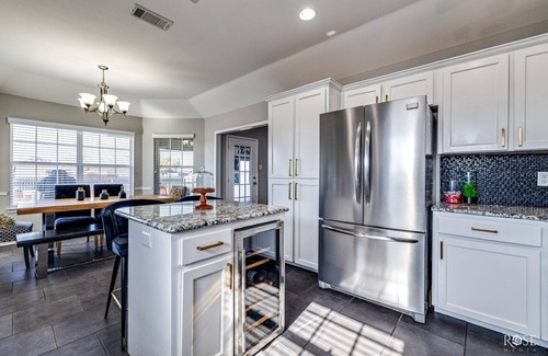 San Angelo House | Stylish corner home with cozy interiors, a private bar, and inviting charm