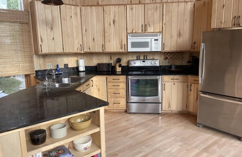 Puposky Cottage | The newly remodeled Stone Cabin with sandy beach and clean clear water