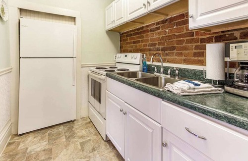 Old West Broad Neighborhood Apartment | This Classical Parlor is located on Chatham Square. It offers a quiet retreat with natural light, floor-to-ceiling windows, and views of the Square.