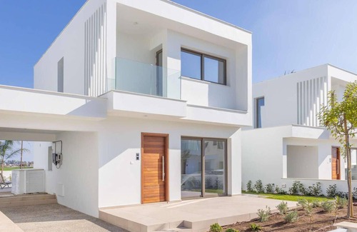 Softades House | This modern villa in a gated complex has pretty landscaped gardens and is within walking distance of