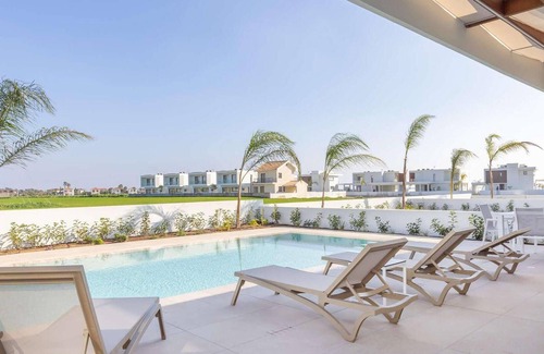 Softades House | This modern villa in a gated complex has pretty landscaped gardens and is within walking distance of