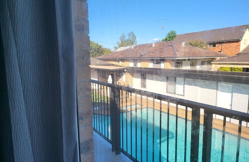 Windsor Apartment | Top View Deluxe Self-Contained Room No 3 with Balcony Overlooking Swimming Pool.