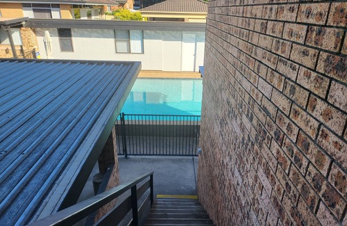 Windsor Apartment | Top View Deluxe Self-Contained Room No 3 with Balcony Overlooking Swimming Pool.