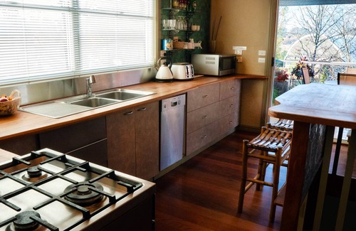 Tawonga South Apartment | Tree Tops Apt @ Dreamers features log fire, mountain + pool views thru tree tops