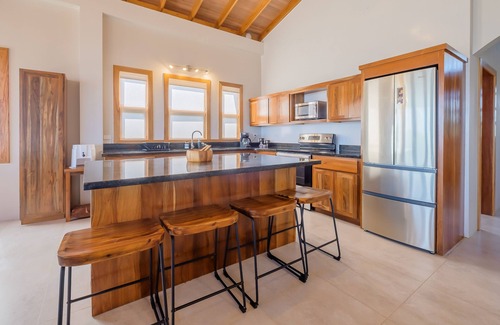 Caye Caulker Villa | Tropical retreat with a pool, dock, bikes, canoes, balconies, and 360 views