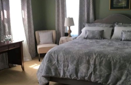 Williston North House | Williston Village INN- Brass room with King size Bed for two people