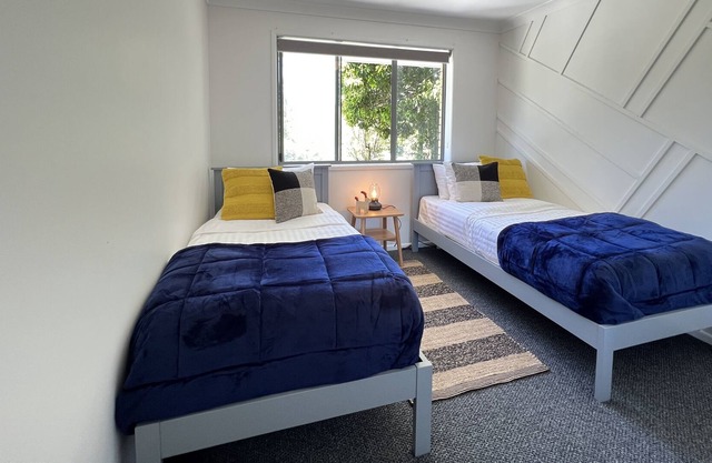 5 Bed Home enveloped by natural beauty, featuring fire pit, lake, & lush gardens