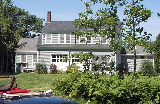 A unique two-story house on the waterfront with a big lawn and stunning views