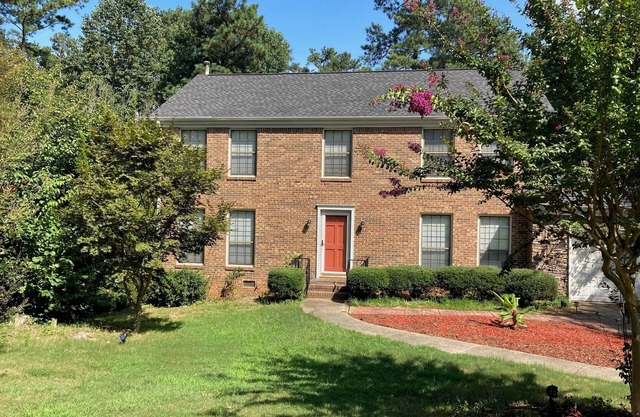 Charming 4-bedroom house with fireplace, sunroom, & massive back yard.
