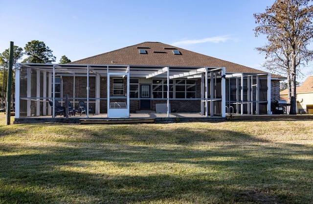 Enjoy this waterfront home with a pool, dock, and Blue Angels! Bring your boat!