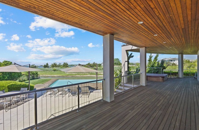 Expansive and Modern Westhampton Home with Open Layout, Private Pool, Water.