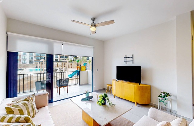 Gorgeous dog-friendly apartment with balcony, open layout, heated pool, & AC