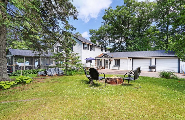 Historic Lake Front Home w/150' lake front on pristine Stone Lake walk to town