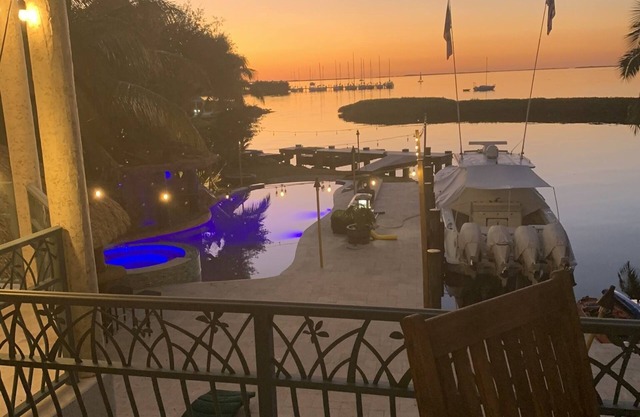 House and guest house with Boat dock, sunsets, jacuzzi, pool, slide, tiki, etc