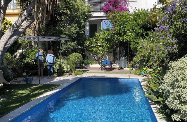 House near the beach with a garden, a roof top and a large swimming pool