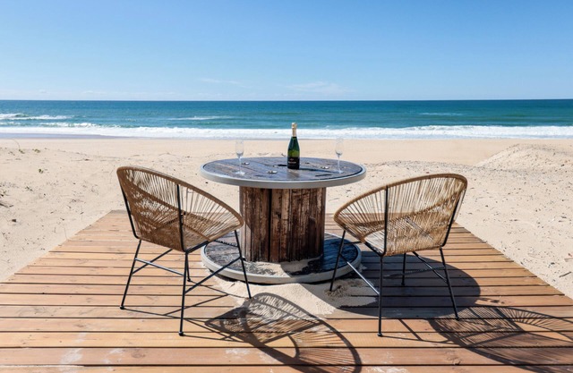 House on the dune with feet in the water