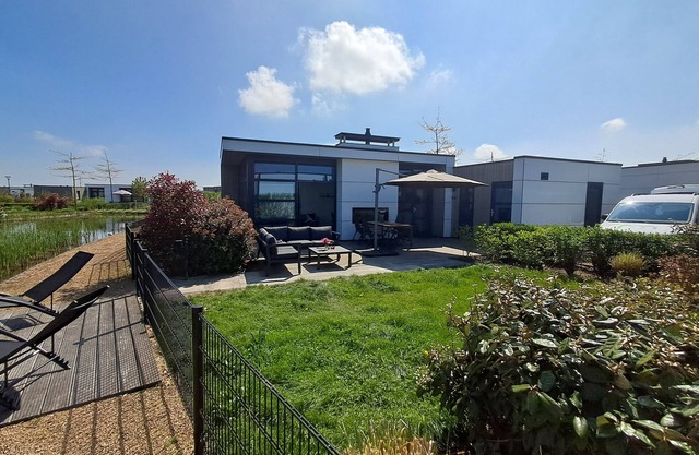 Modern chalet with fenced garden, sauna, outdoor pool and river view in Olburgen