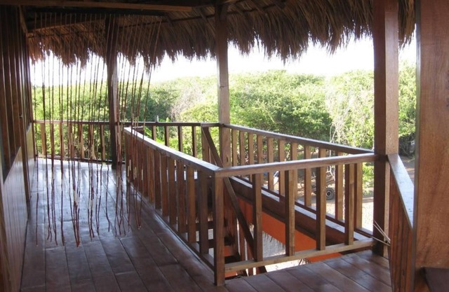 Room with king size bed and shared bathroom, sea and garden view