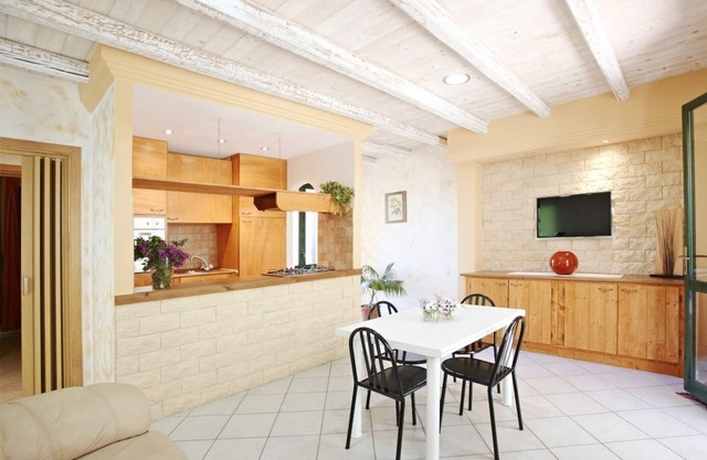 Seaside villa with garden and panoramic mountain views.