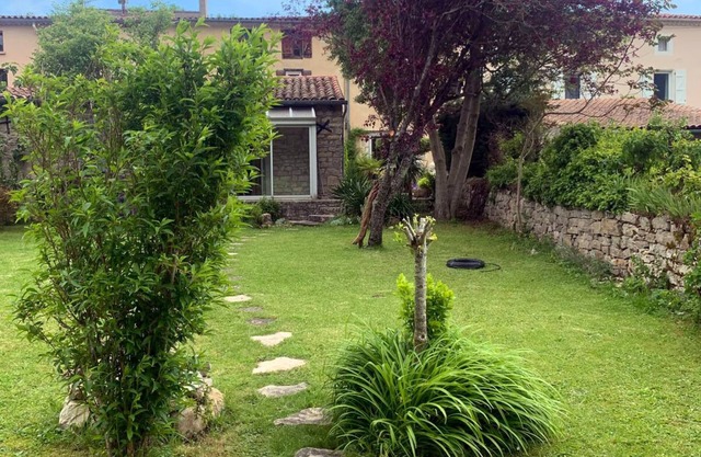 Small village house set in the garden of a rural family home