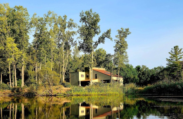 Spacious contemporary home on 4 wooded acres and 200' of private lake front.