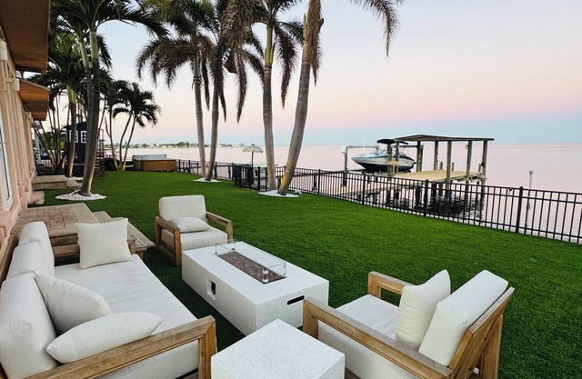 Spacious Waterfront Tropical Oasis: Hot Tub, Dock & Turf