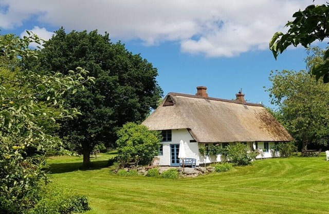 Thatched cottage in the meadow