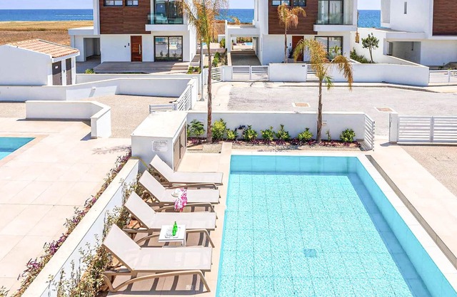This brand-new villa, situated on an exclusive gated development with landscaped gardens, is only mi