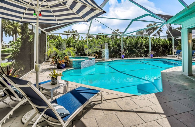 Waterfront escape in the heart of the action with pool, spa, grill, & WiFi