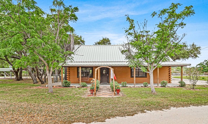 Rockport Cabin | 2-story cabin with an enclosed yard, patio, and large shade trees