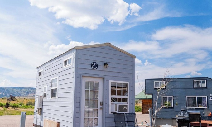 Meeker House | Adorable Tiny Home with two lofts. Both are accessible by ladder. One has a Queen mattress and the other has a Twin mattress. Home also contains a folding Full futon on main level. Sleeps: 4