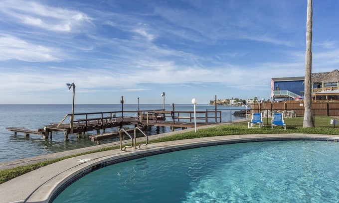 South Padre Island Condo | Beautiful Bayfront Condo with Fishing Pier, Boat Dock & Pool - Next to Louie's!