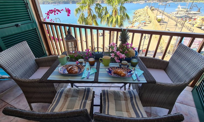 Porto Azzurro Apartment | Blue harbor lovely apartment with terrace above the beach.