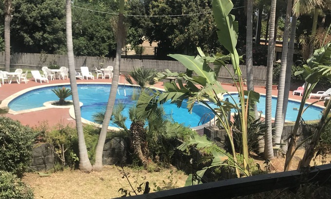 Acireale Apartment | Capomulini villa with private garden, descent to the sea and seasonal swimming pool.