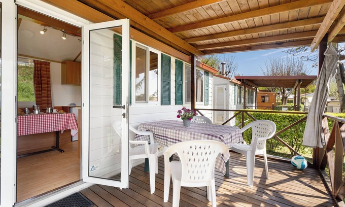 Pratolungo RV Rental | Caravan 'Mobile Home Comfort Standard' with Lake View, Shared Pool and Wi-Fi