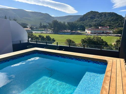 Hermanus City-Centre Apartment | Central Town Duplex with Pool, BBQ & Mountain View