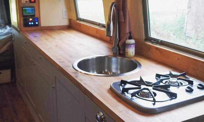 Larkspur House | Cozy camper by the creek, surrounded by serenity and nature.