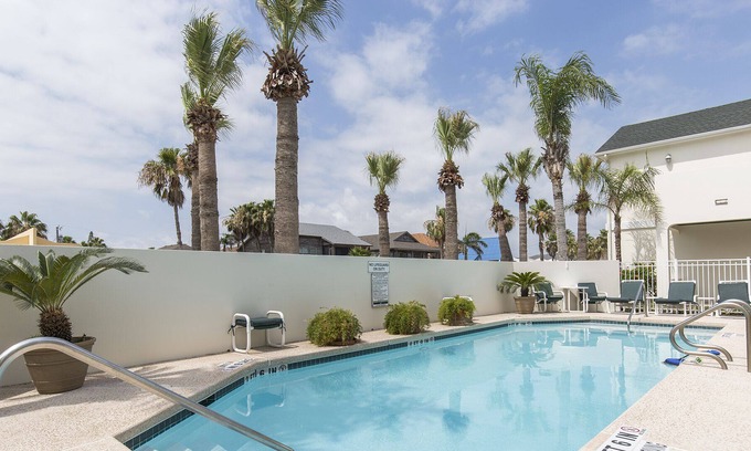 South Padre Island Condo | Cute Coastal Condo with Sparkling Pool! Walk to Beach in minutes!