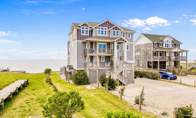 Salvo House | Dazzling waterfront home with balconies, private pool, hot tub, & game room