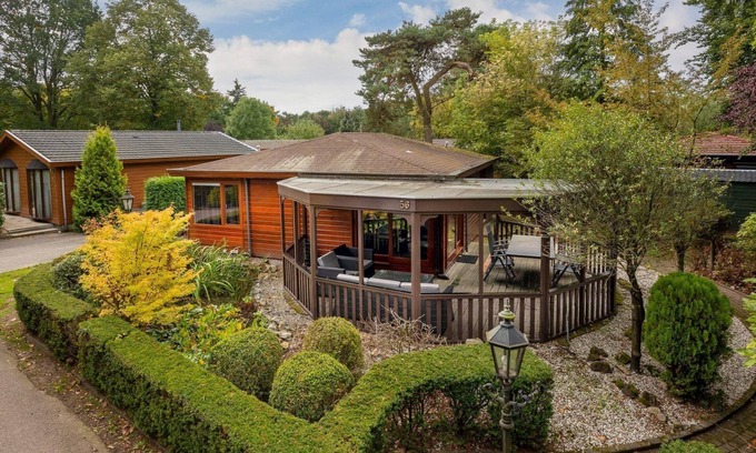 Municipality of Harderwijk House | Discover the beautiful Veluwe Lodges: a spacious and comfortable retreat to relax. Enjoy the cozy living room, open kitchen, and private garden.