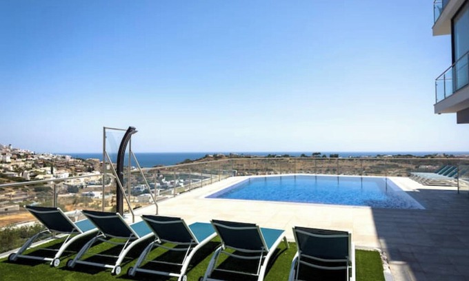 Patio Condo | Elegant apartment overlooking the sea with infinity pool, beach 5 minutes away.