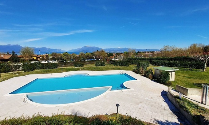 Desenzano del Garda Apartment | Elegant flat with large terrace in residence with swimming pool