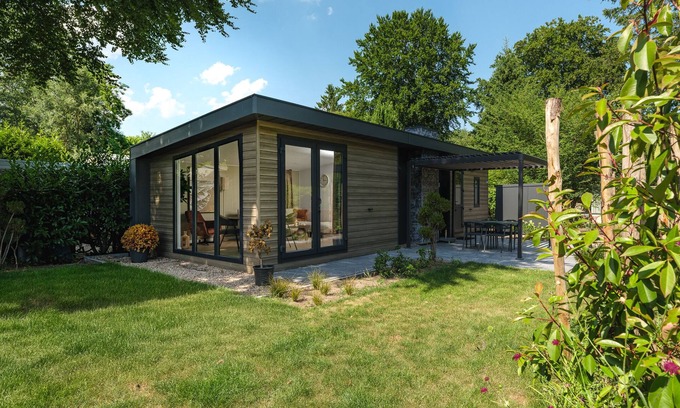 Lieren House | Enjoy a holiday home in the wooded nature of the Veluwe, complete with modern amenities and a stylish pergola and electric outdoor fireplace for optimal comfort.